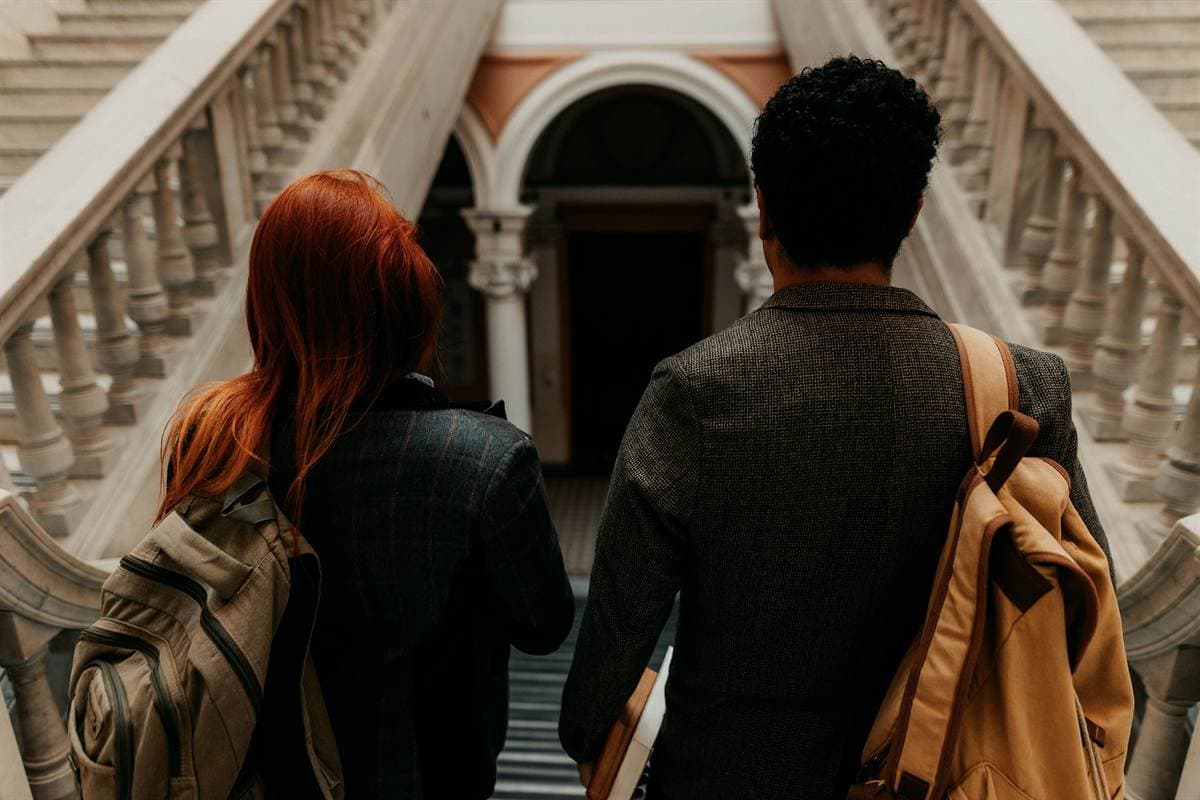 A stone staircase in a university building, shot with motion blur.